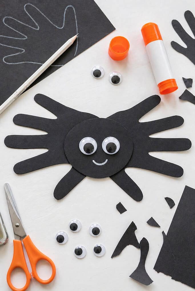 A cute, non-scary spider made from two overlapping black paper handprints