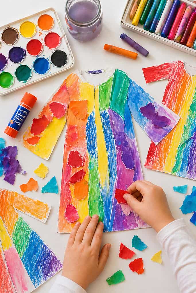 a simple coat shape cut from white cardstock, richly decorated with vibrant colors.