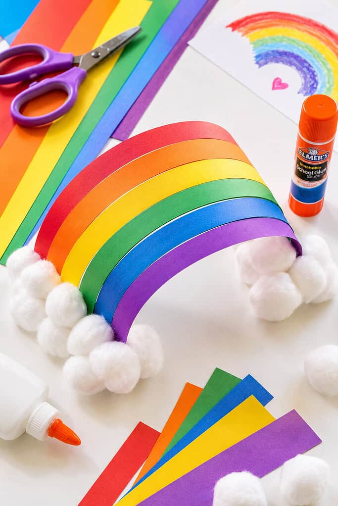 a handmade standing 3D rainbow craft created from curved strips of colored construction paper