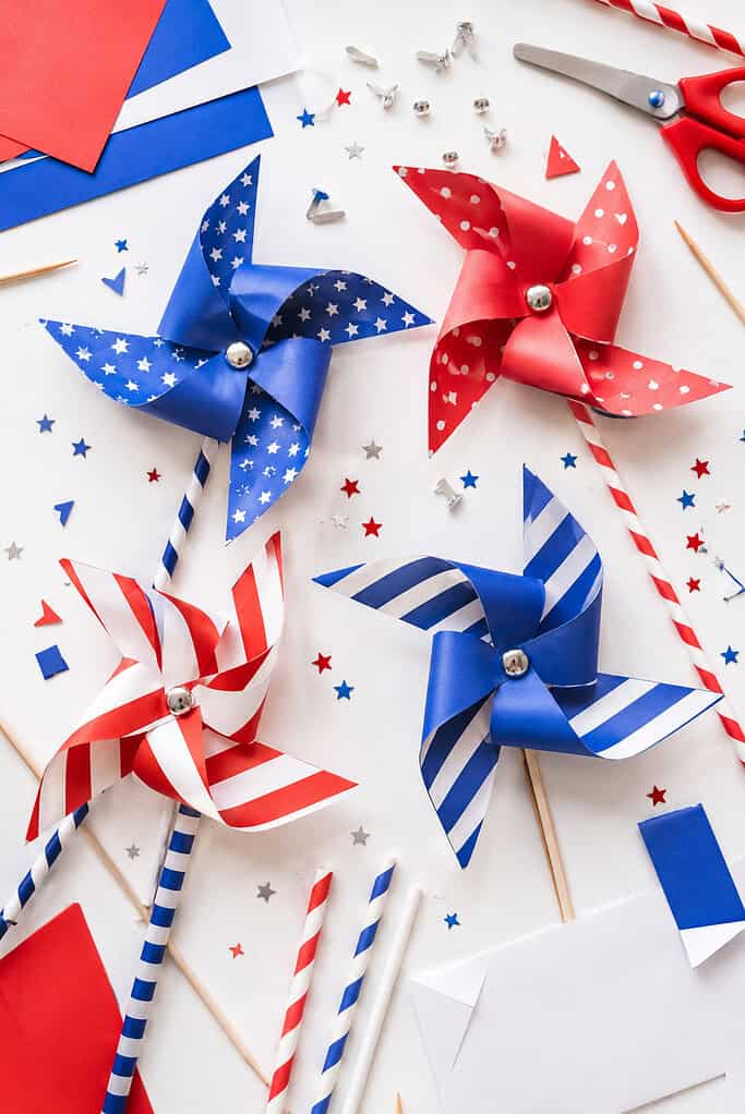 several completed patriotic paper pinwheels made from red, white, and blue cardstock