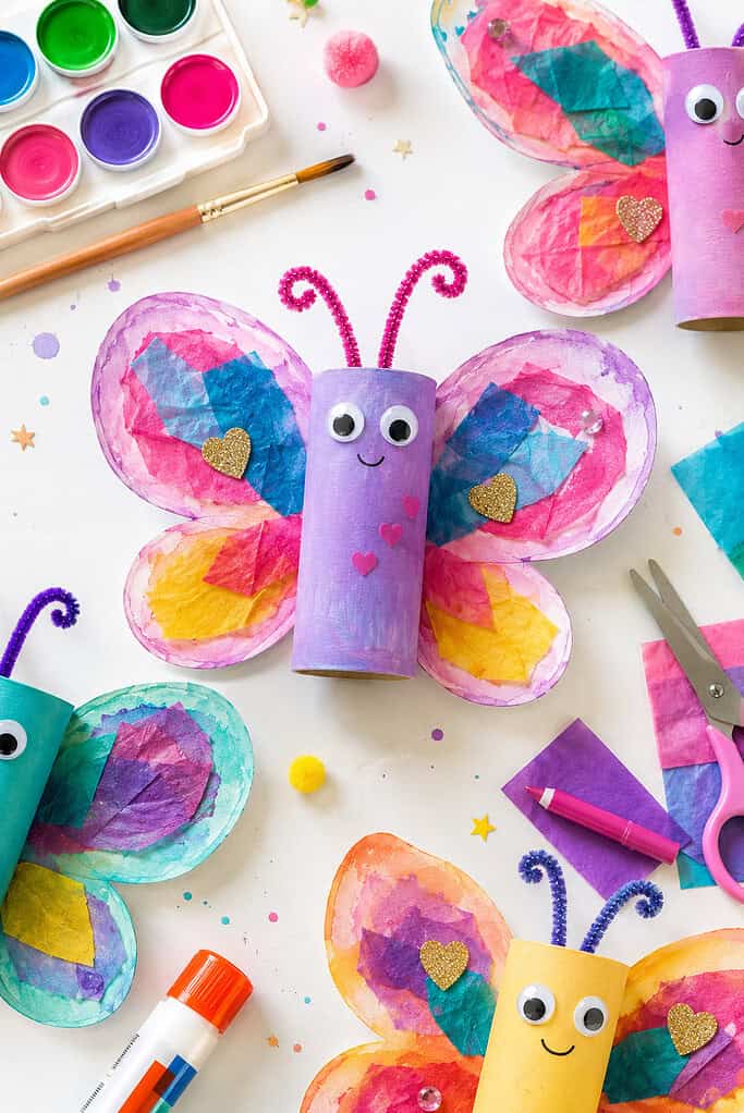 a colorful handmade butterfly created from a recycled toilet paper roll