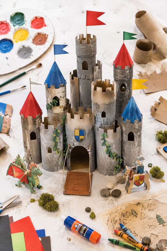 a whimsical handmade castle created from recycled toilet paper rolls glued together at varying heights