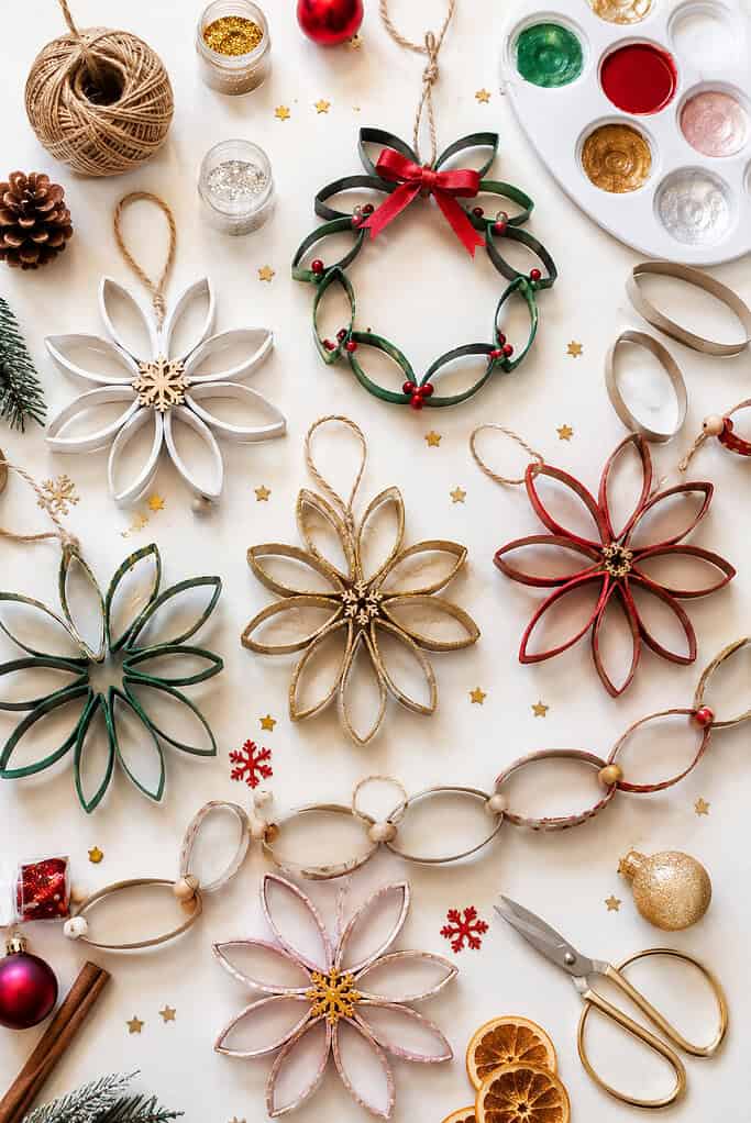 delicate handmade ornaments created from sliced toilet paper roll rings shaped into soft ovals and looped together into wreaths, snowflakes, garlands, and floral-inspired Christmas decorations.