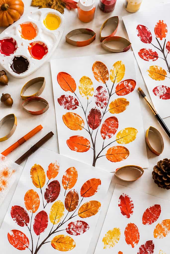 handmade autumn leaf artwork created using flattened toilet paper rolls as paint stamps