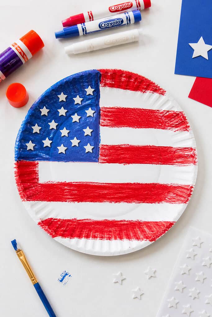 A simple, child-made American flag using a paper plate as the base