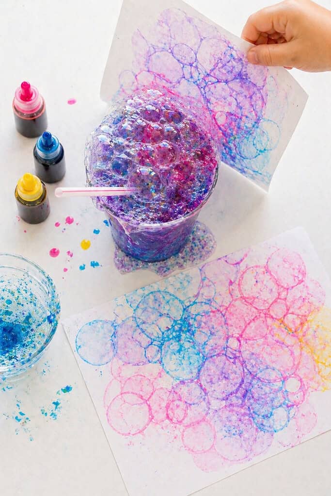 a cup filled with colorful, foamy bubbles overflowing at the top