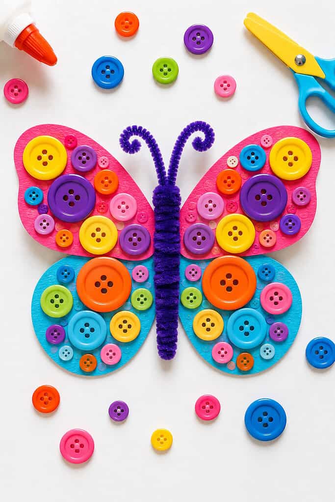 a handmade butterfly created from cardstock wings decorated with colorful buttons arranged in playful patterns