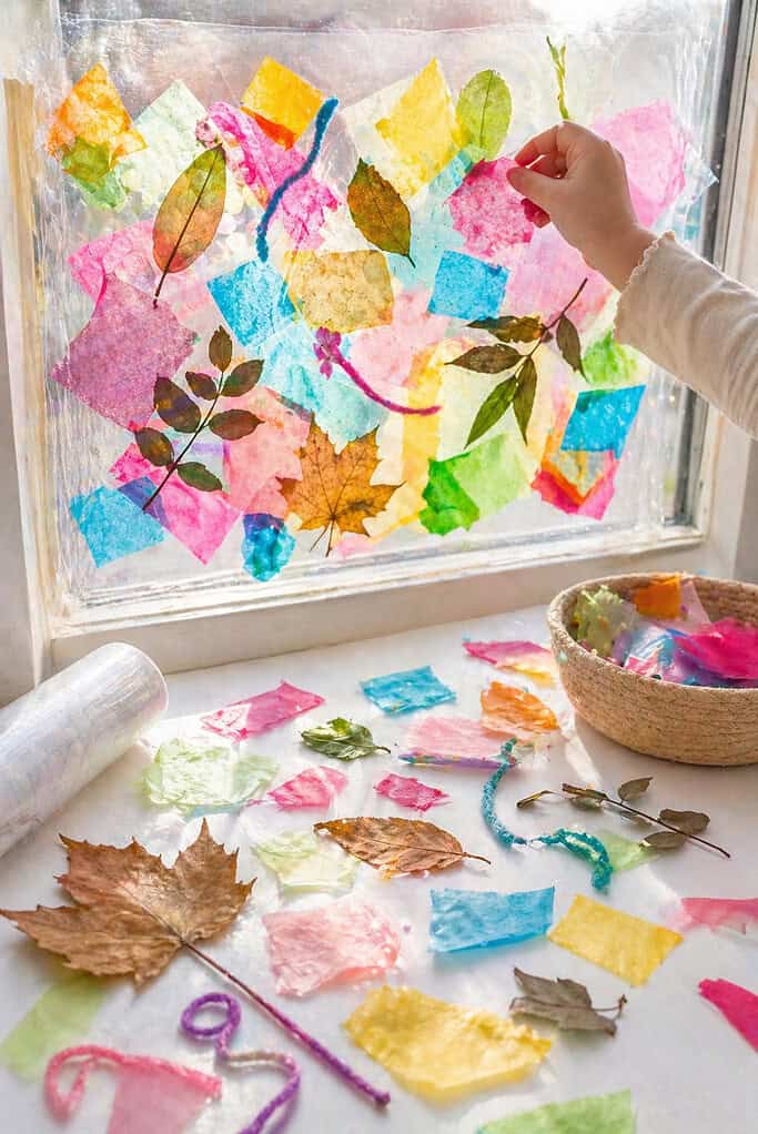 a sheet of clear contact paper taped sticky-side-out onto a vertical surface (such as a sunlit window or propped transparent panel)