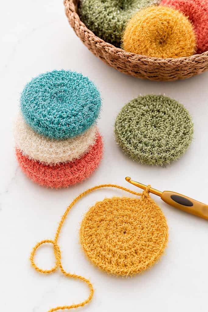 round and slightly textured crochet scrubbies in vibrant cheerful colors
