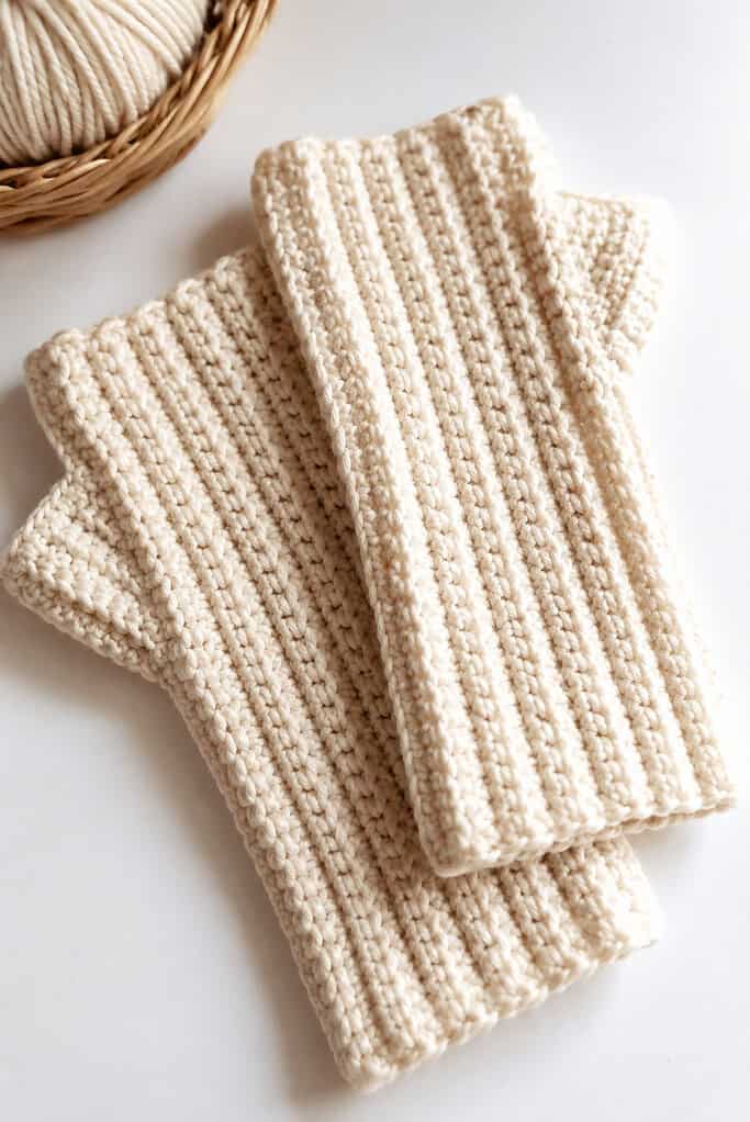 a pair of handmade crochet fingerless gloves