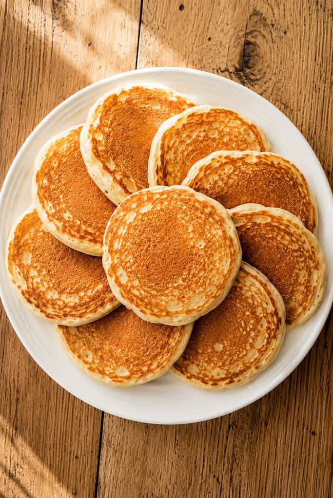 fluffy homemade fresh milled flour pancakes arranged in a circular pattern