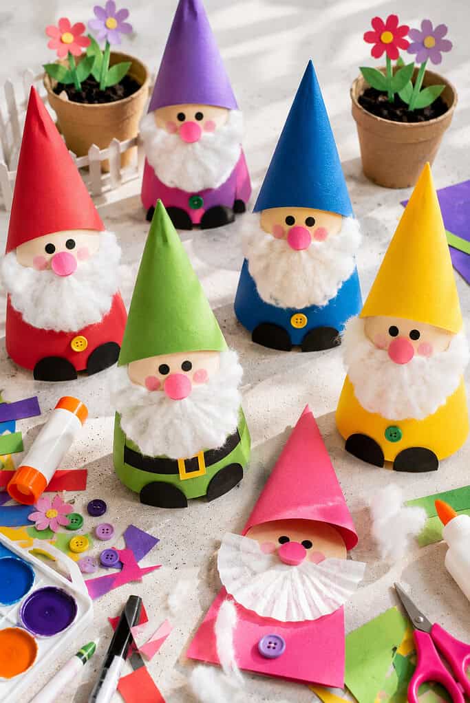 several handmade garden gnome crafts arranged together like a tiny cheerful gnome village