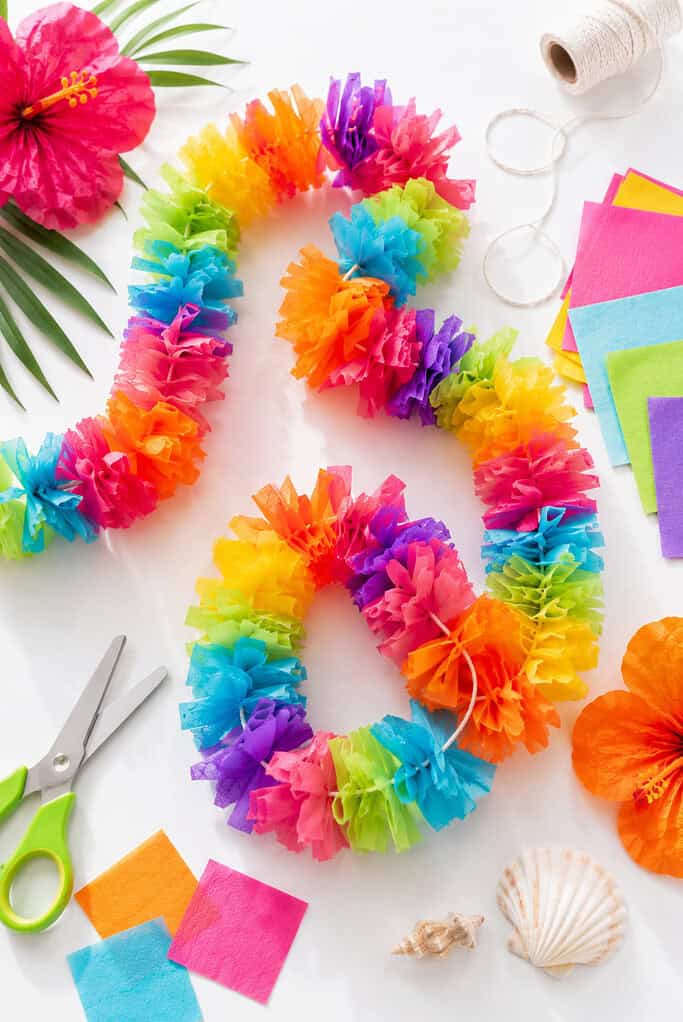 Colorful handmade tissue paper leis threaded onto yarn or string.