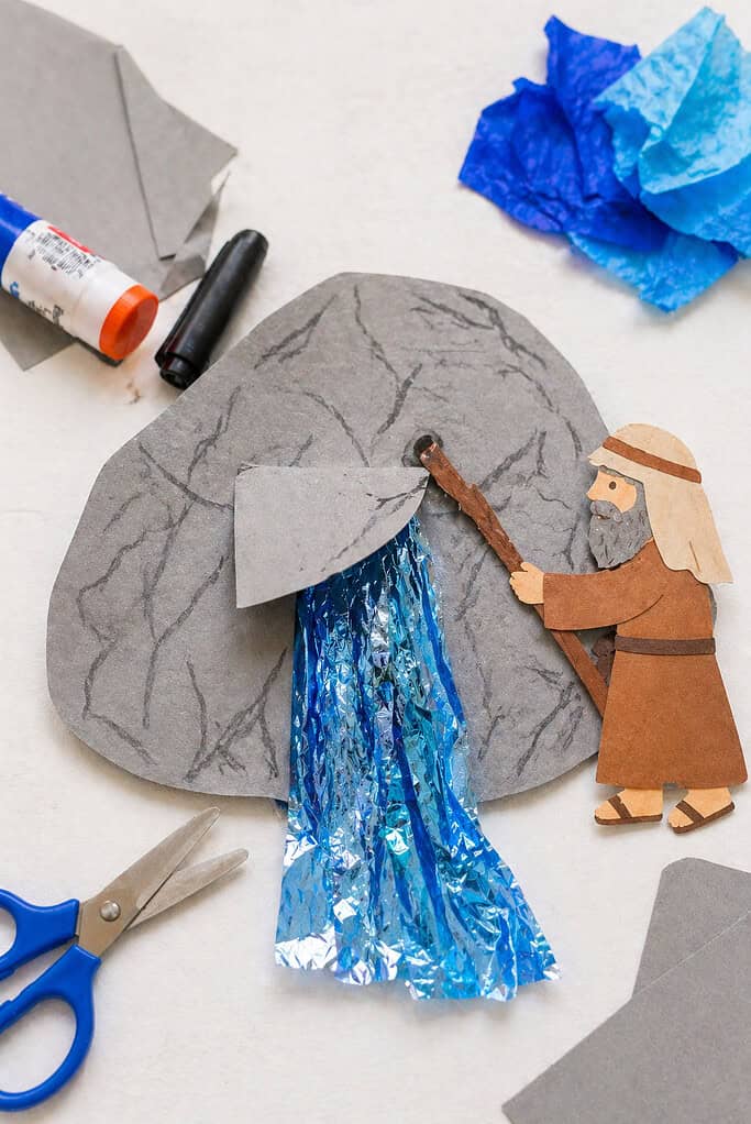 a gray cardstock rock shape, roughly cut with slightly uneven edges to reflect a child-made craft.