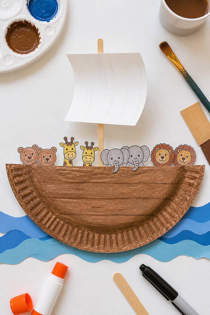 A paper plate folded cleanly in half to form the hull of a small boat, with visible creases and slight imperfections for a handmade feel.