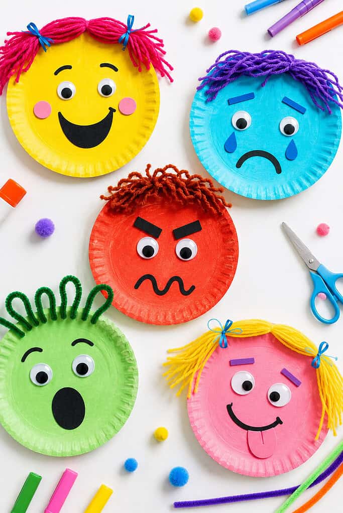 decorated paper plates transformed into expressive emotion faces such as happy, sad, angry, surprised, and silly