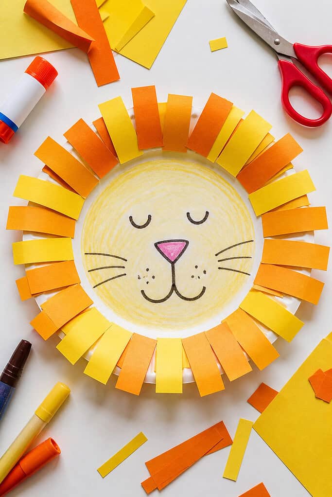 A white paper plate transformed into a sweet, childlike lion.