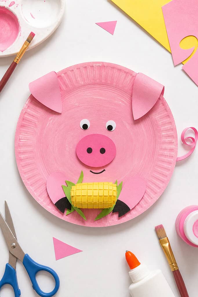 A paper plate painted a soft, warm pink with visible transformed to a pig