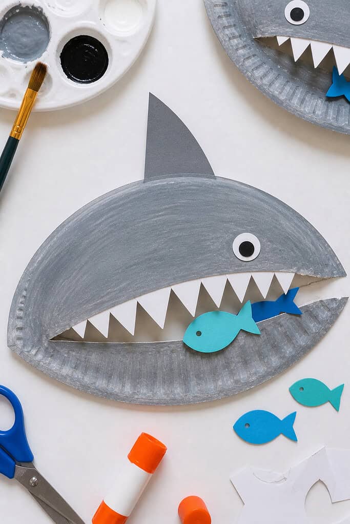 A paper plate painted a cool, slightly uneven gray with visible brush strokes for a natural, childlike texture.