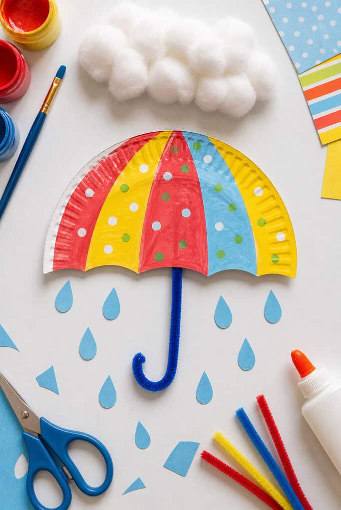 A paper plate cut cleanly in half to form the umbrella canopy