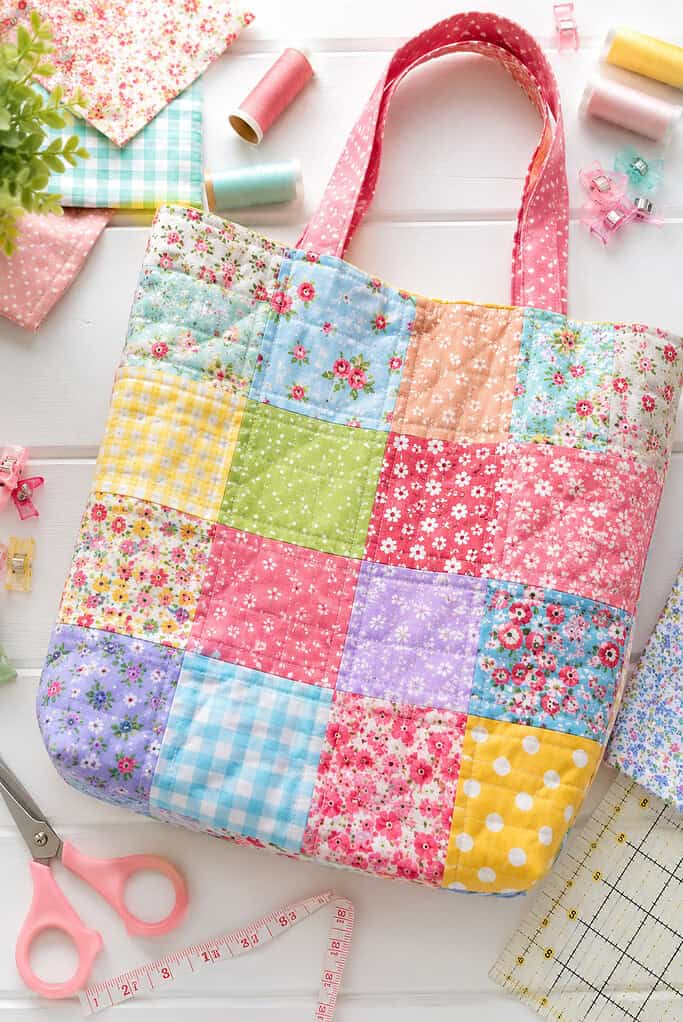 tote bag that feature vibrant fabric squares in mixed floral, gingham, polka dot, and pastel prints.