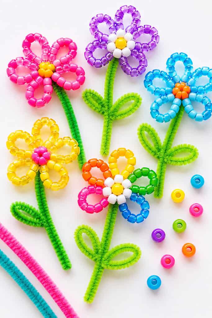 handmade flowers created by threading colorful pony beads onto fuzzy pipe cleaners before shaping them into simple flower forms