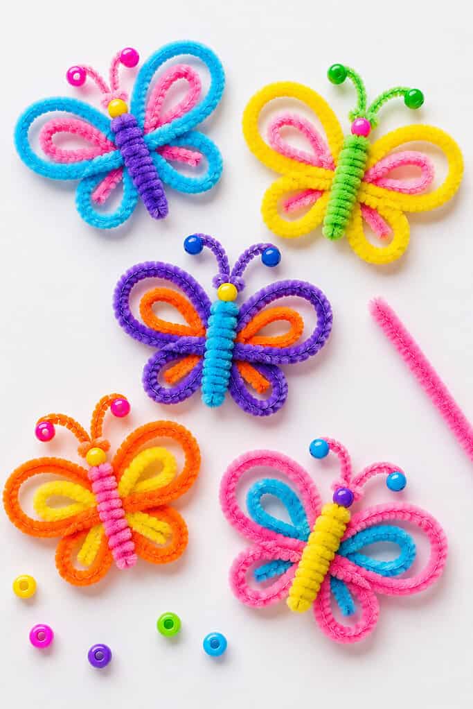 several cheerful handmade butterflies crafted from colorful fuzzy pipe cleaners