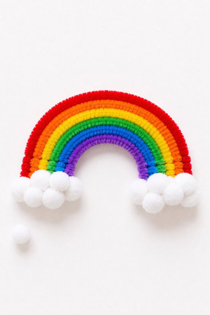 a handmade rainbow crafted from six or seven fuzzy pipe cleaners layered in classic rainbow order