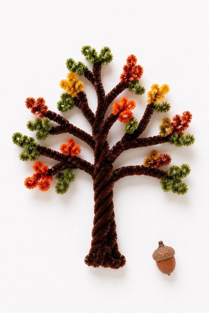 a handmade tree crafted from twisted brown fuzzy pipe cleaners forming a textured trunk with branching limbs spreading outward naturally