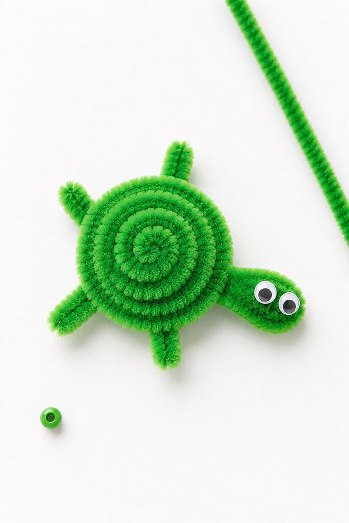 a handmade turtle crafted from fuzzy green pipe cleaners