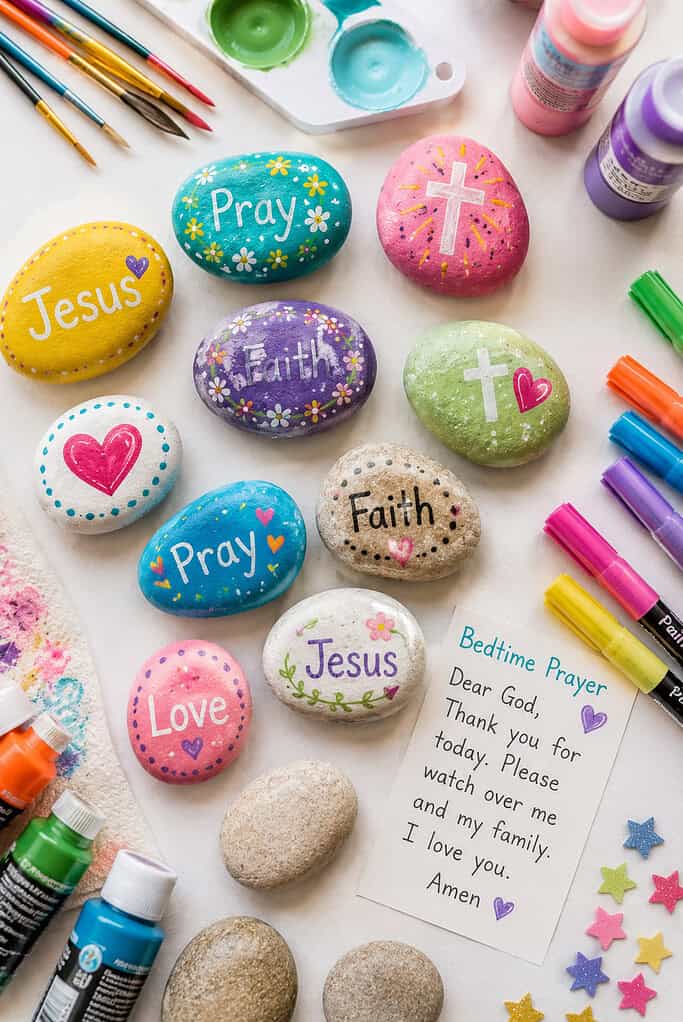several smooth hand-painted prayer rocks