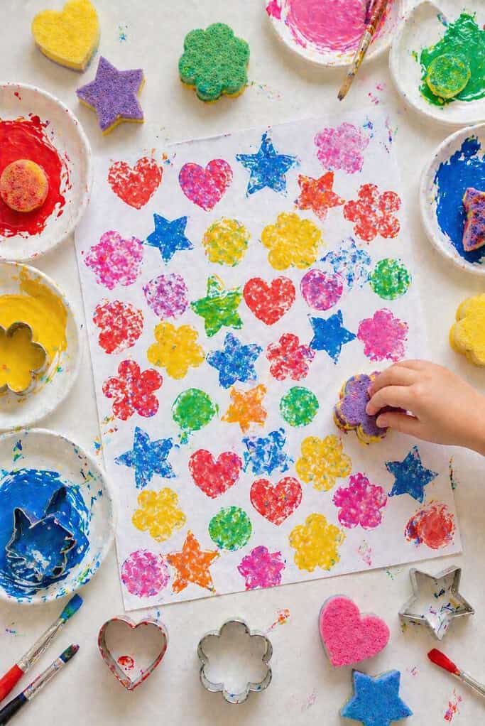 a large sheet of paper filled with hand-stamped patterns—stars, hearts, flowers, and simple shapes
