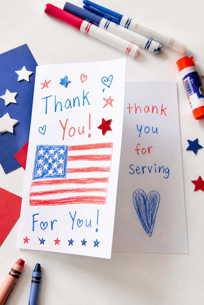 A folded piece of cardstock, slightly open to reveal both the decorated front and a glimpse of the inside message.