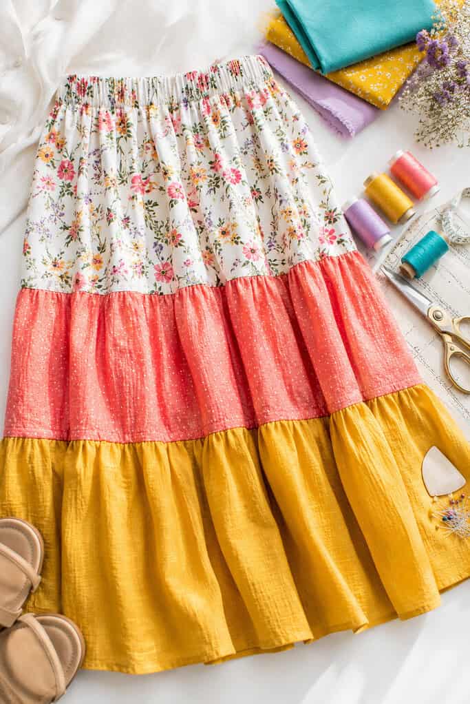 A beautifully sewn tiered midi skirt with three gathered ruffle tiers