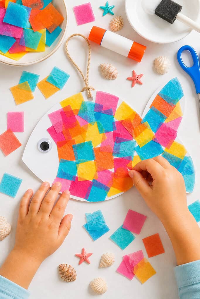 a simple fish craft cut from white cardstock, with the body and tail formed in one charming childlike shape