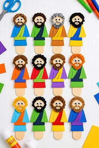 twelve distinct handmade disciple figures made from vibrant craft materials such as colored paper, popsicle sticks, foam sheets, markers, googly eyes, yarn, and stickers.