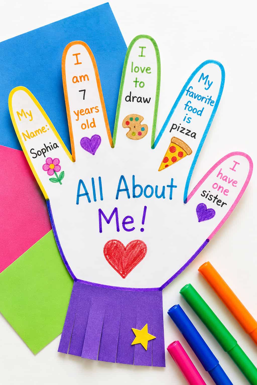 a single kid-made "All About Me" paper craft in a flat lay composition on a bright white tabletop.