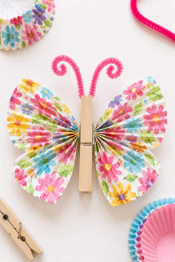 two colorful patterned cupcake liners pinched together in the center and fanned out to form delicate butterfly wings.