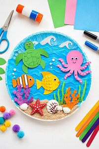 a colorful ocean-themed kids craft project displayed on a bright white tabletop