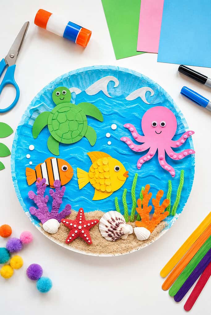 a colorful ocean-themed kids craft project displayed on a bright white tabletop