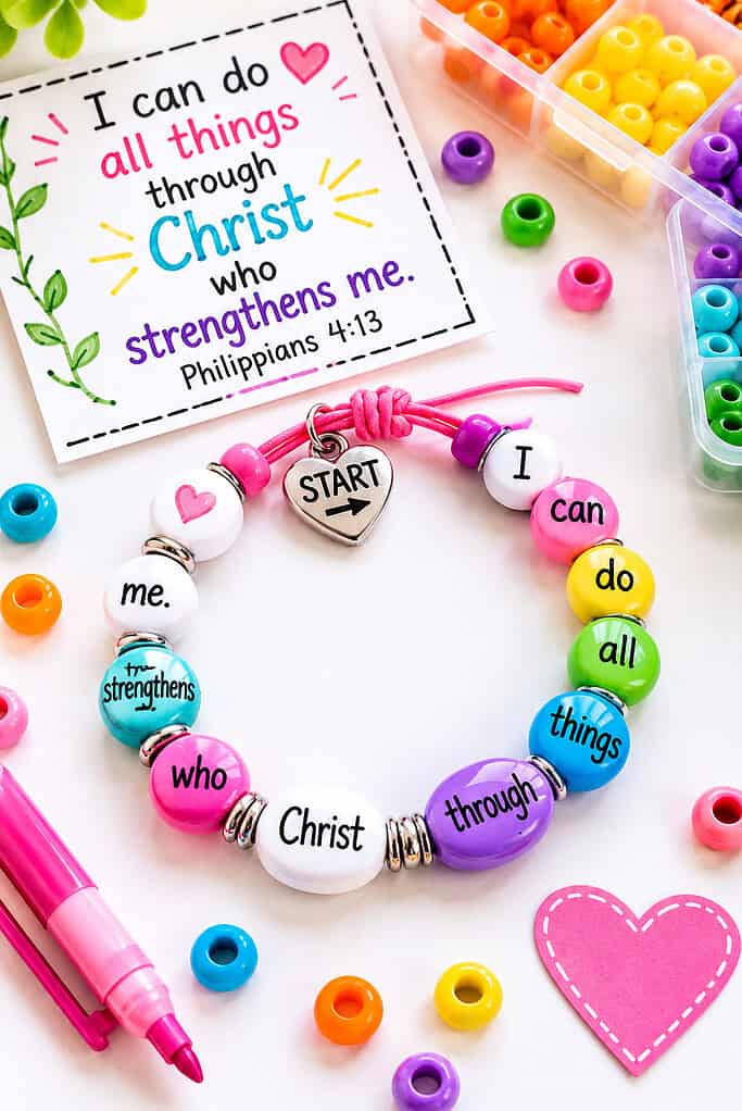 a handmade bracelet made from vibrant beads strung on a cord, with each bead color representing a different word in a short Bible verse.