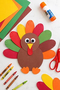 A cheerful handmade turkey craft created from vibrant construction paper
