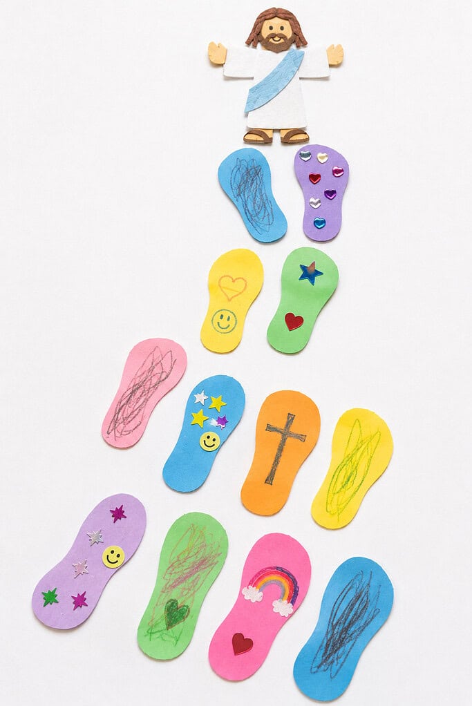 a path of colorful paper footprints stretching across the frame.