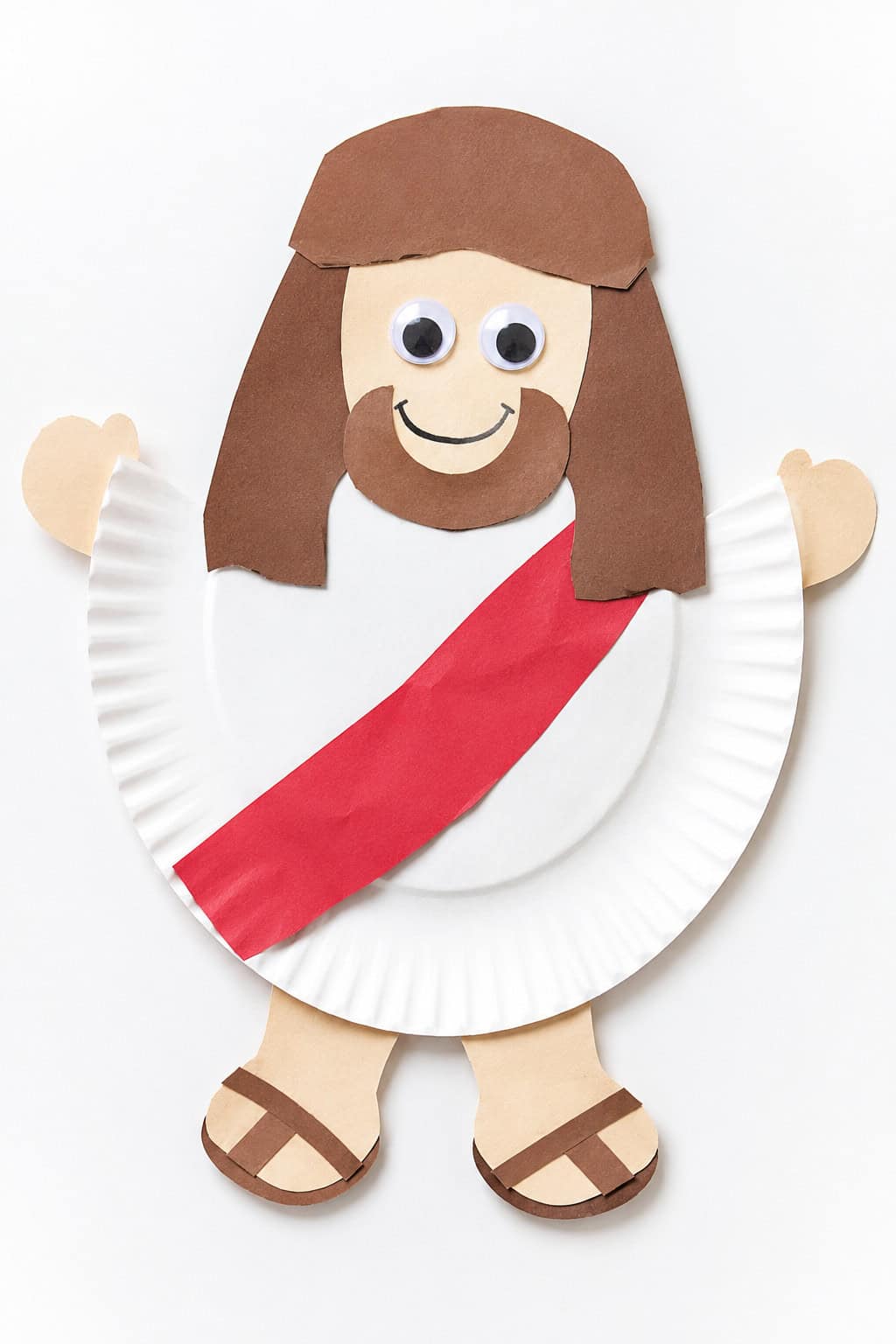 a simple, handmade Jesus craft created from basic children's craft supplies such as construction paper, cardstock, glue, scissors, googly eyes, and a paper plate.