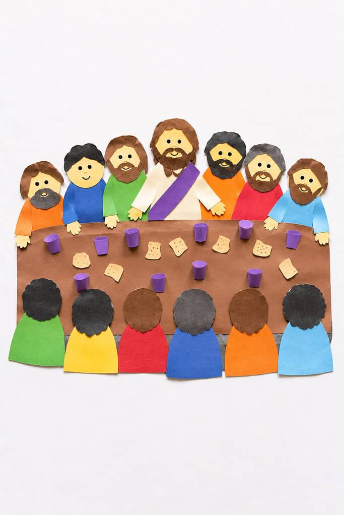 a long paper table made from hand-cut brown construction paper with simple paper figures representing Jesus and His disciples seated around it
