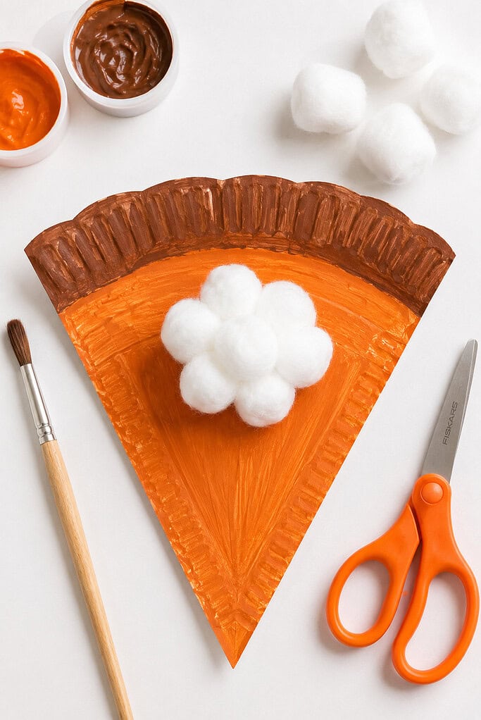 A paper plate transformed into a slice of pumpkin pie.