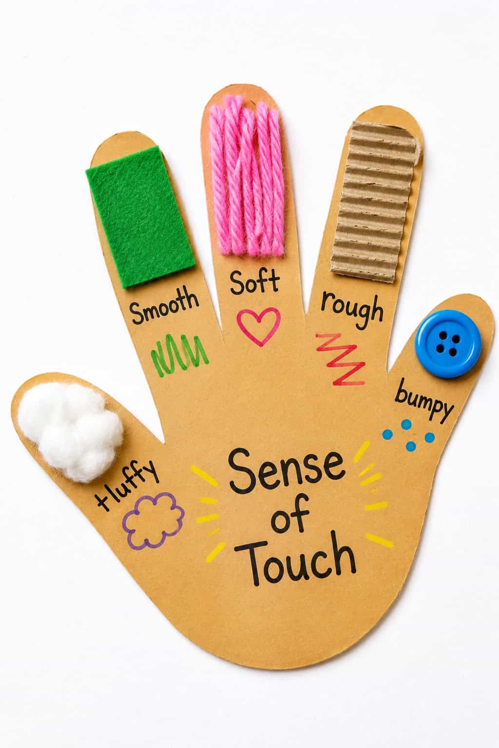 Preschool five senses hand craft with colorful textures for teaching touch, including cotton, felt, yarn, cardboard, and a button.