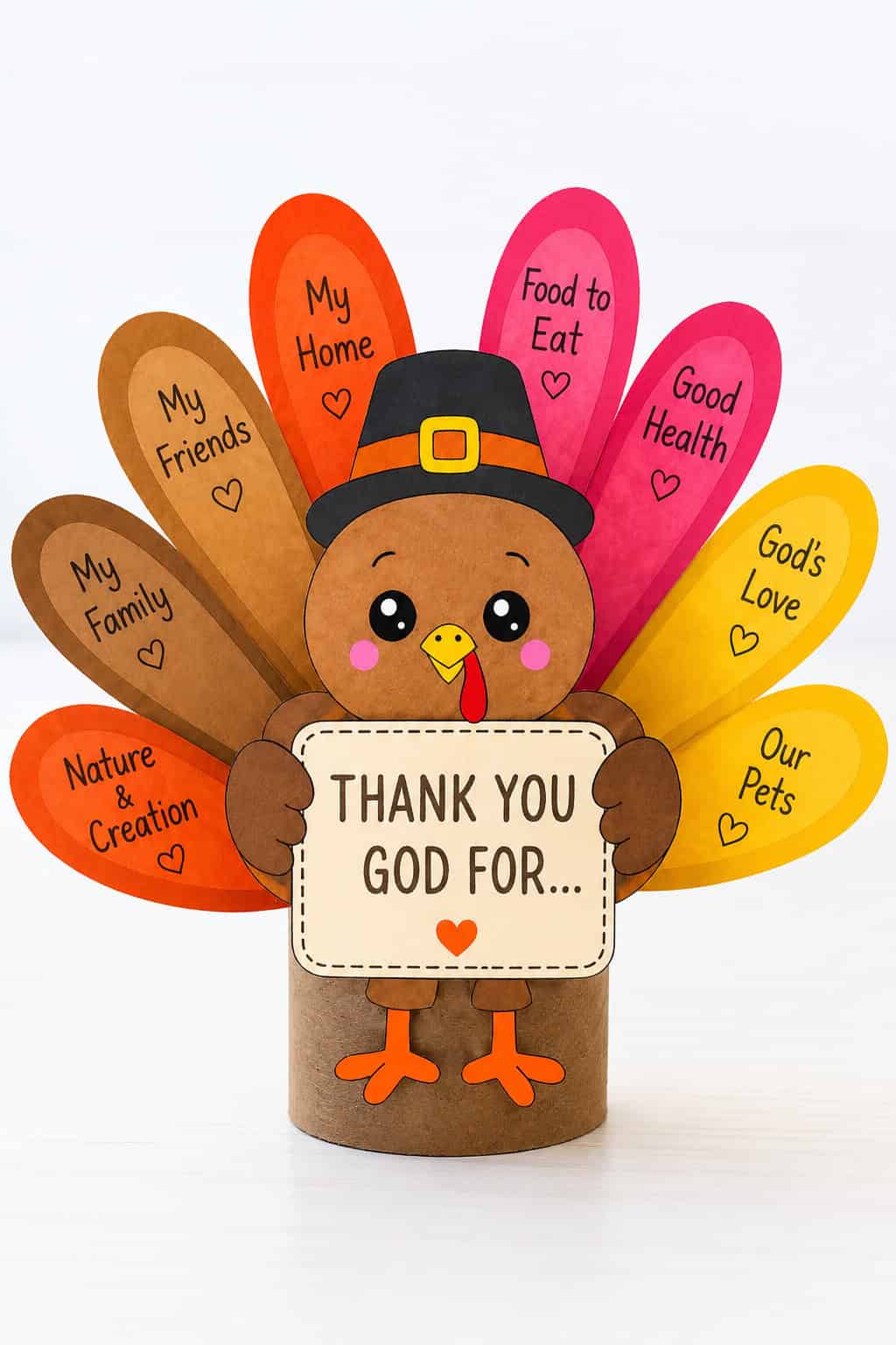 A paper turkey craft in a black pilgrim hat standing on a brown toilet paper roll with eight brown, red-orange, pink, and gold feathers fanned behind it