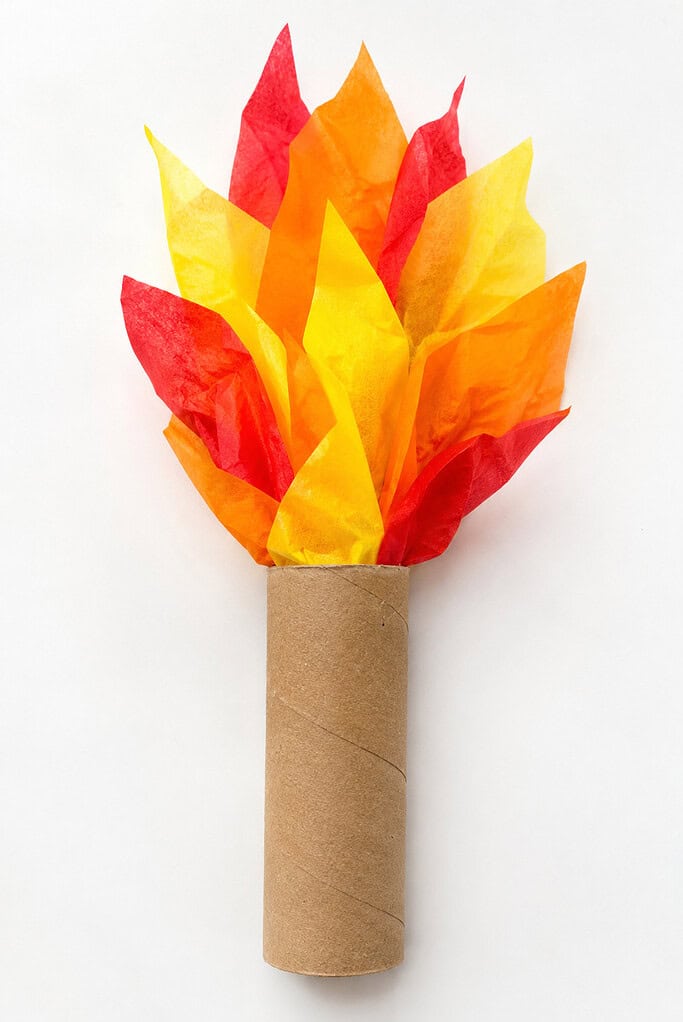 A paper torch craft with a cardboard-tube handle and layered red, orange, and yellow tissue-paper flames.