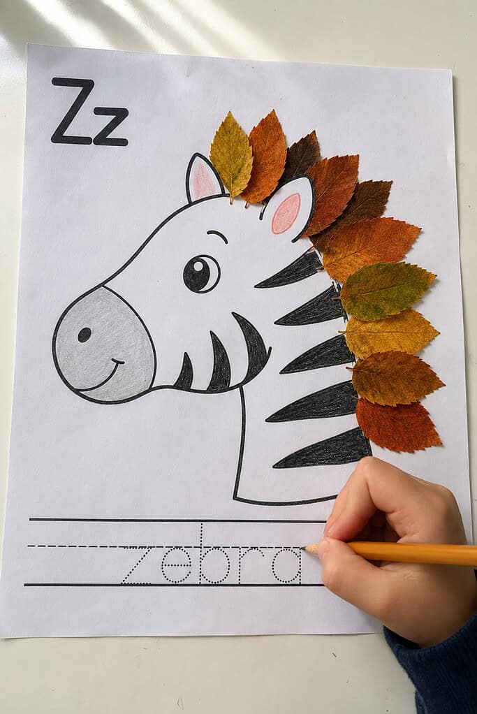 A child tracing the word on a leaf alphabet craft hedgehog page while the drawing is partly colored
